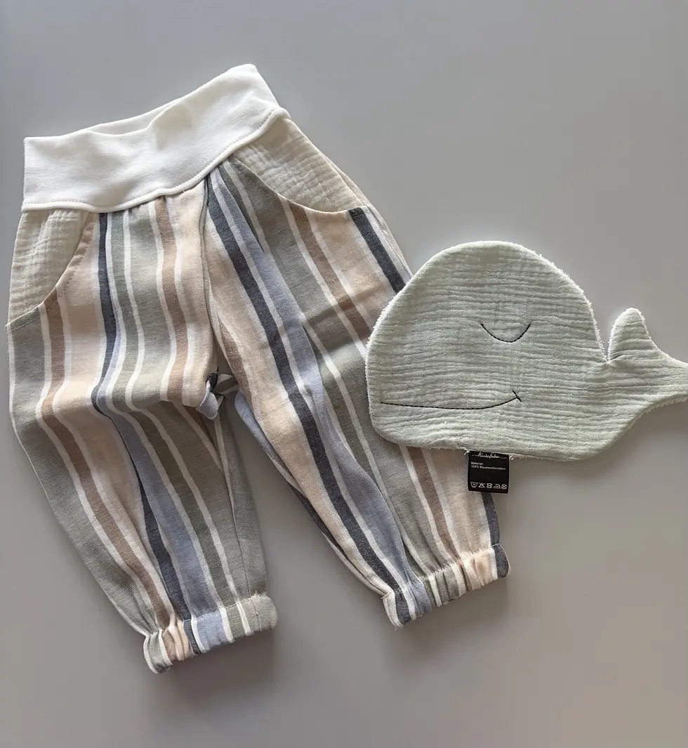 Miniaturbild: Musselinhose Janni Küstenstreifen als Flatlay mit Wal-Waschlappen und Kissen. Handmade Babyhose aus Baumwolle, weich und somm