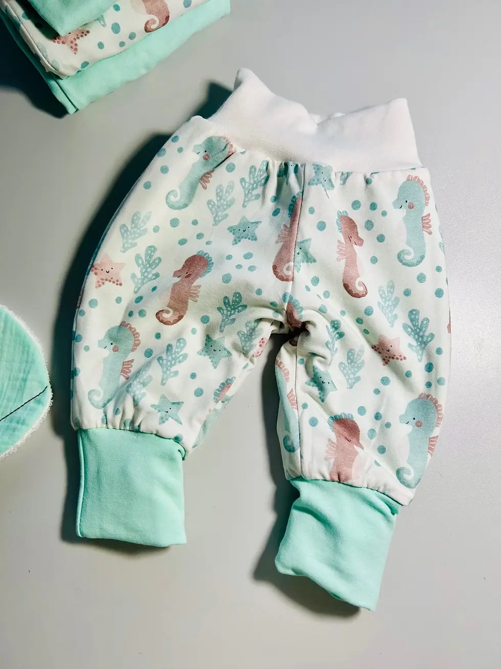 Miniaturbild: Mitwachsende Babyhose mit Wal- und Seepferdchen-Motiv aus Bio-Baumwolle. Bequem geschnitten, langlebig und handgemacht.