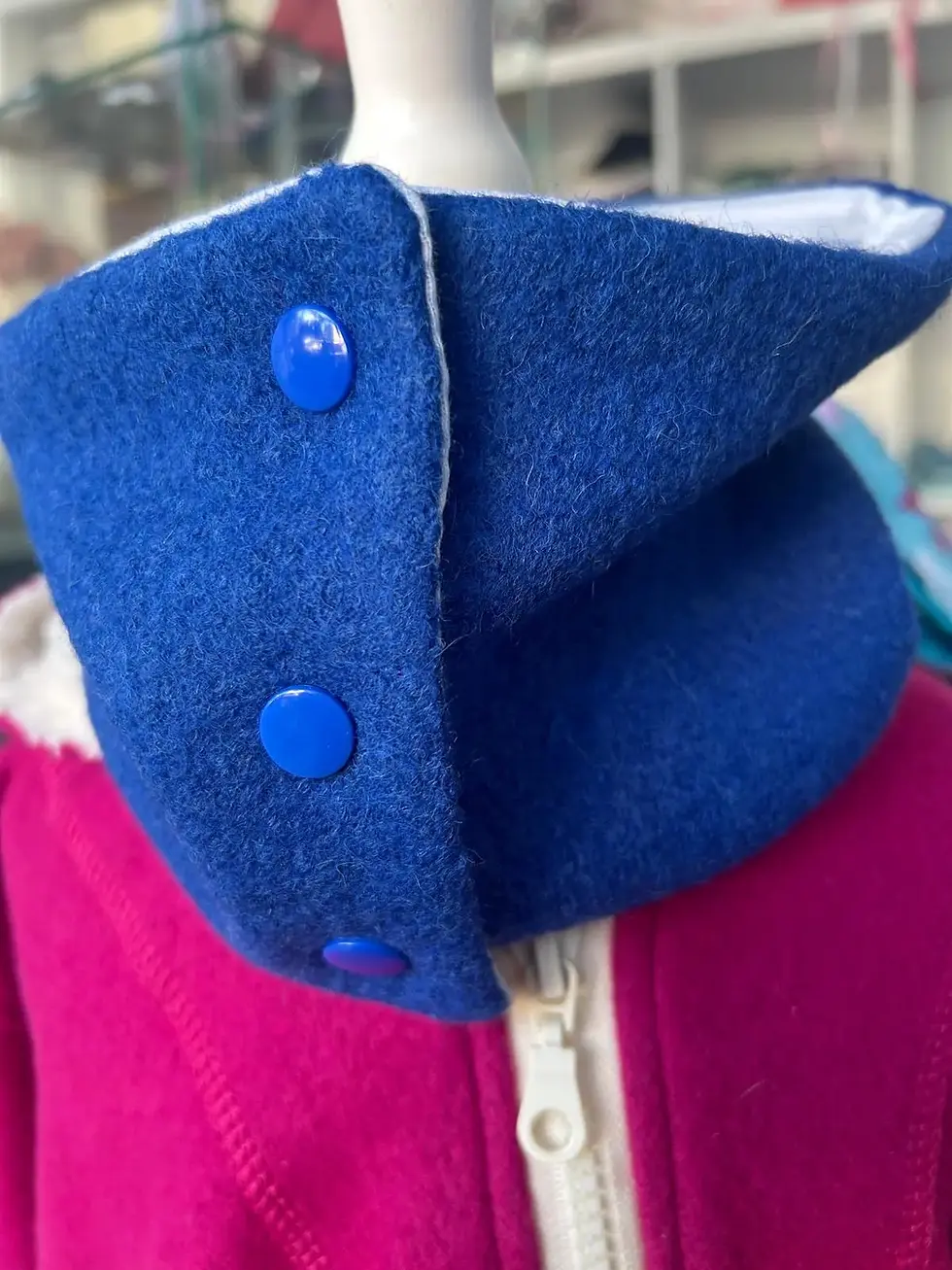Knöpfbarer Walk-Loop Meeresstreifen aus ozeanblauem Wollwalk mit drei blauen Druckknöpfen.