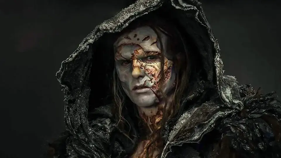 A grotesque human face with many facial scars and wearing large hood looks angry and contemplative