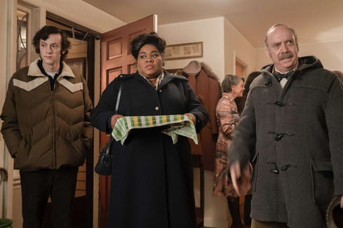a student, a school cook holding a plate of food, and a teacher all wearing winter coats arriving at someone's party in a house
