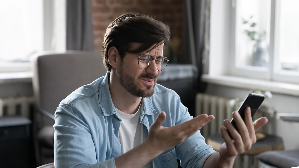 man frustrated and confused by his phone.