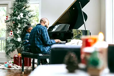 st-christmas-tree-piano-dad-daughter.webp