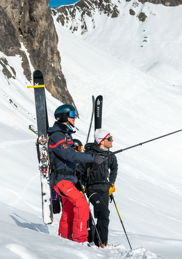 Ski instructor and student in the snow during a private lesson
