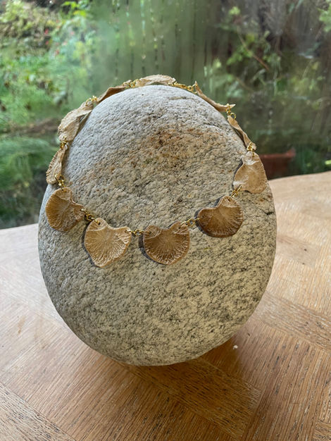 in memoriam, found bones, intervertebral discs, gold metal and granite, 18 x 17 x 18 cm, 2024