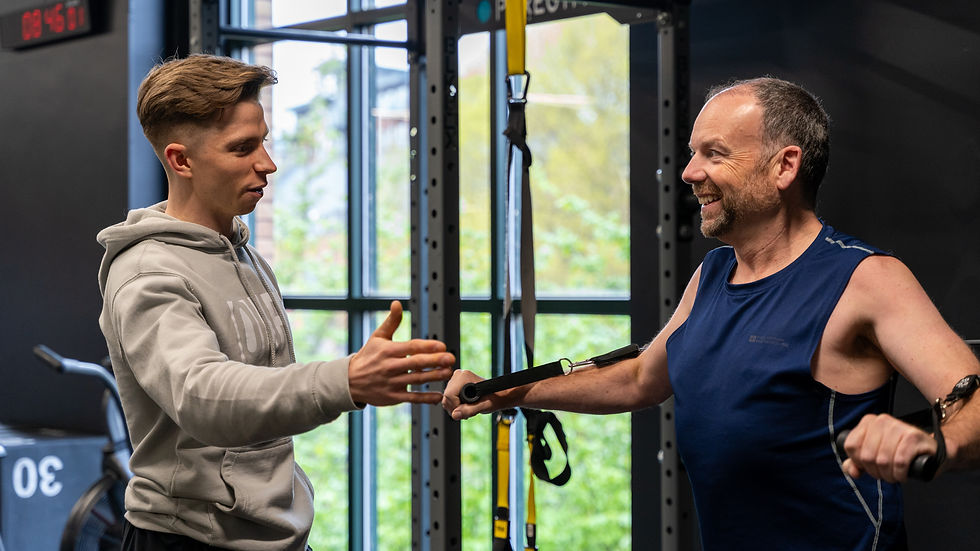 Personal Trainer coaching client on TRX bands in the gym