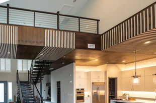 Walnut accent ceiling on catwalk, stairs and kitchen