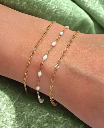 Three gold-filled stack bracelets with one white beaded chain