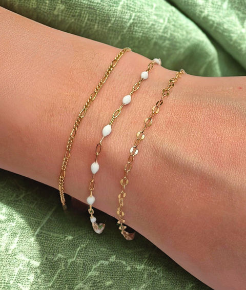 Three gold-filled stack bracelets with one white beaded chain