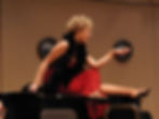 Opera singer in red dress performing on stage with pianist during OperaWorks program