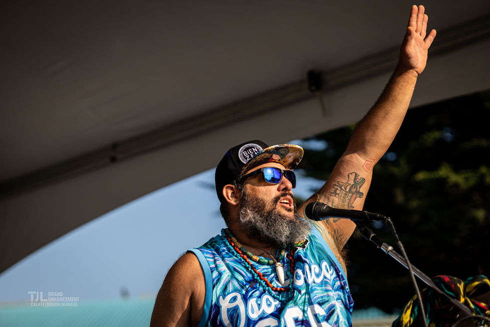 Lead vocalist of Sensory Tribe engaging the crowd at West End Celebration 2024, captured by TJL Brand Enhancement.