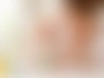 Parent gently brushing a smiling baby’s first teeth