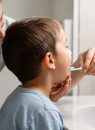a mon brushing her toddler's teeth