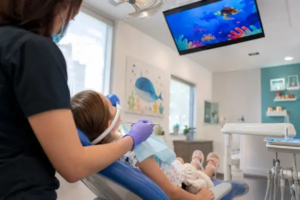 child watching a movie during a crown re-cement in Erie CO