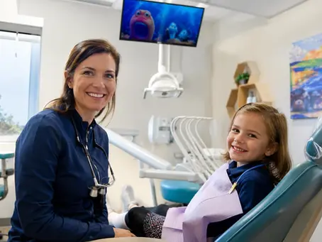 Dentist with a young patient at her Erie pediatric dental office