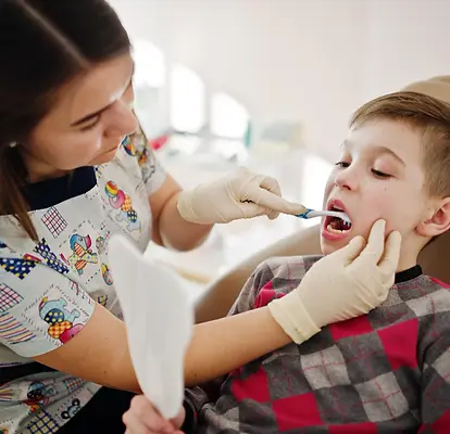 Fluoride treatment for kids in Broomfield CO - dental hygienist applying fluoride to child