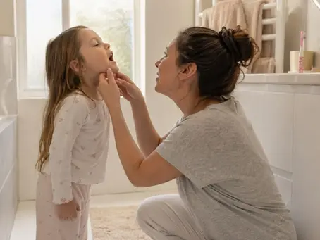 Parent checking child's mouth for gum disease