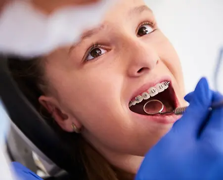 Girl with braces during a routine, dental examination