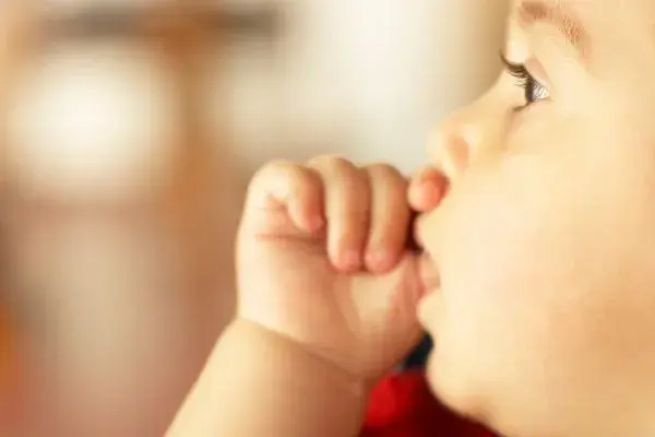 Baby sucking thumb while resting peacefully