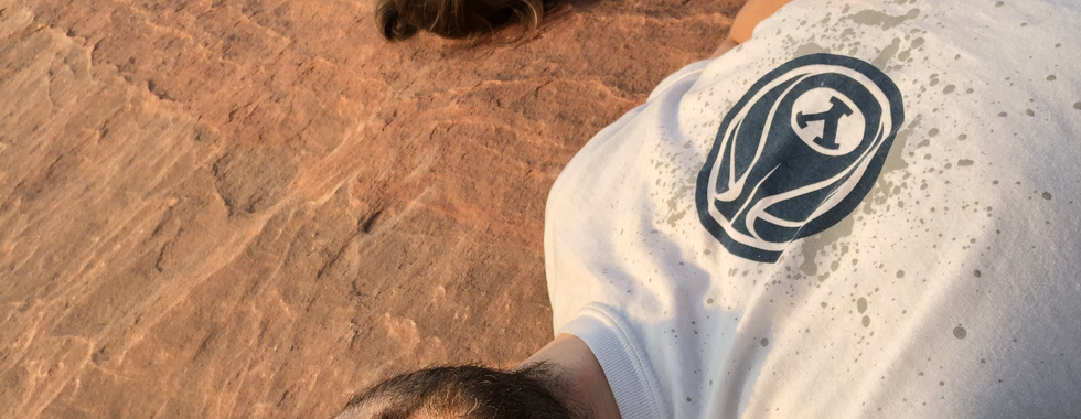 Patrice Carey Hale and husband lying on the redrock at Moonshine Wash