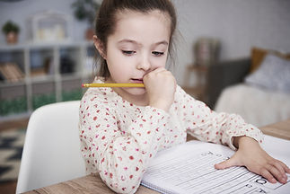 focused-girl-doing-her-homework-home.jpg