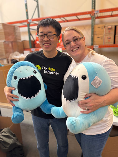 volunteers holding toys