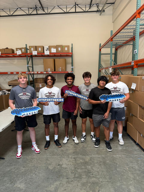 Teen volunteers holding signs