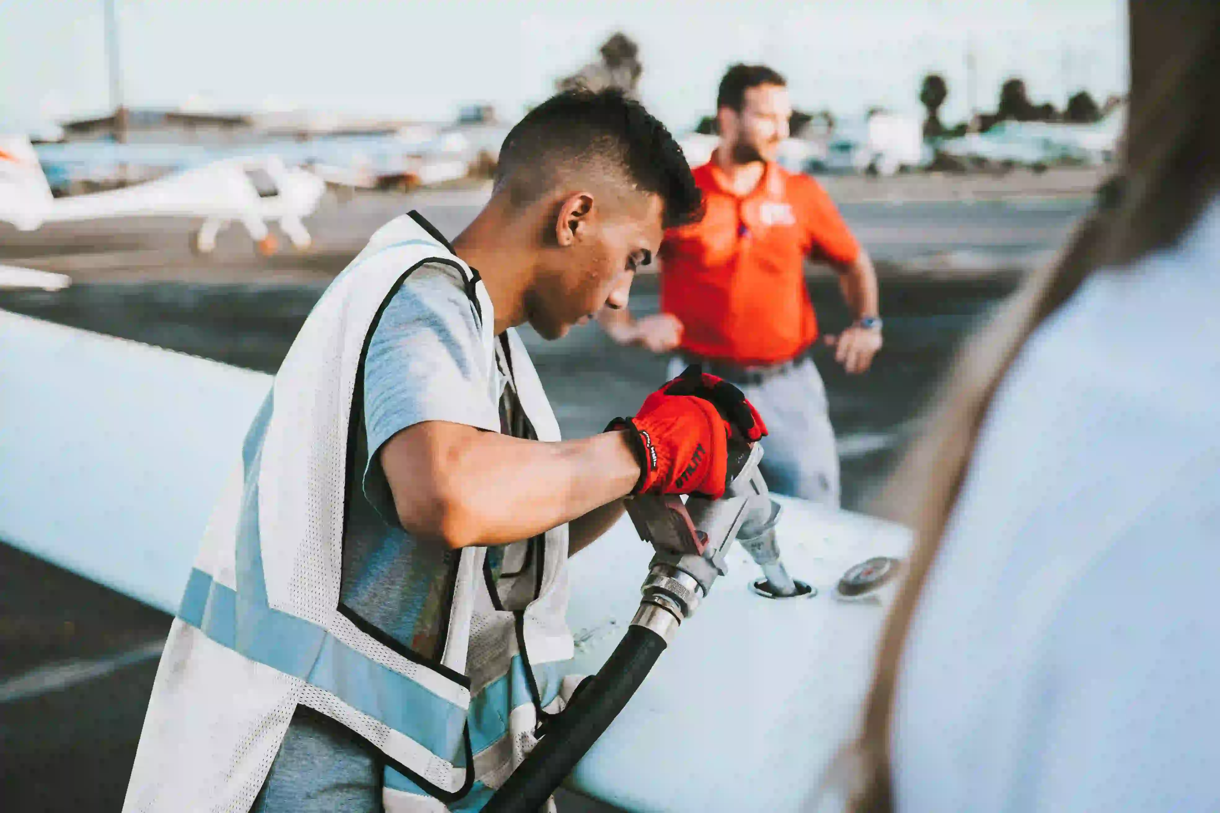 Young Worker Fueling Airplane