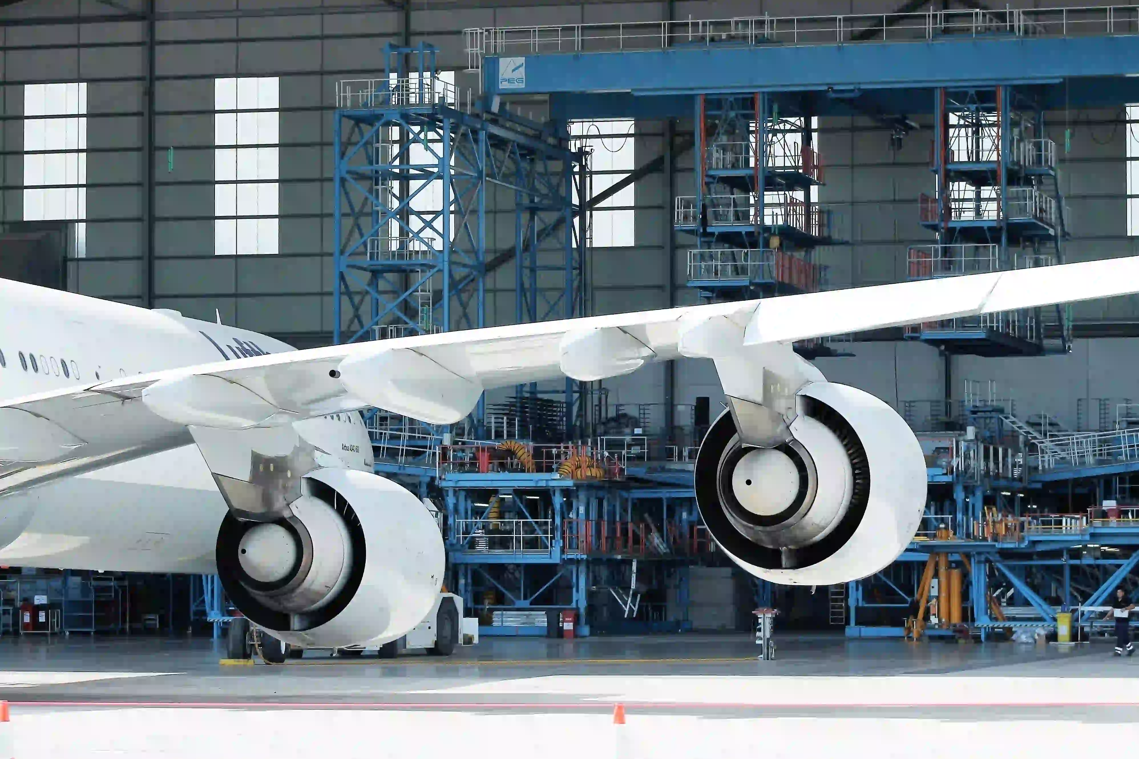 Jet getting maintenance inside a hangar.