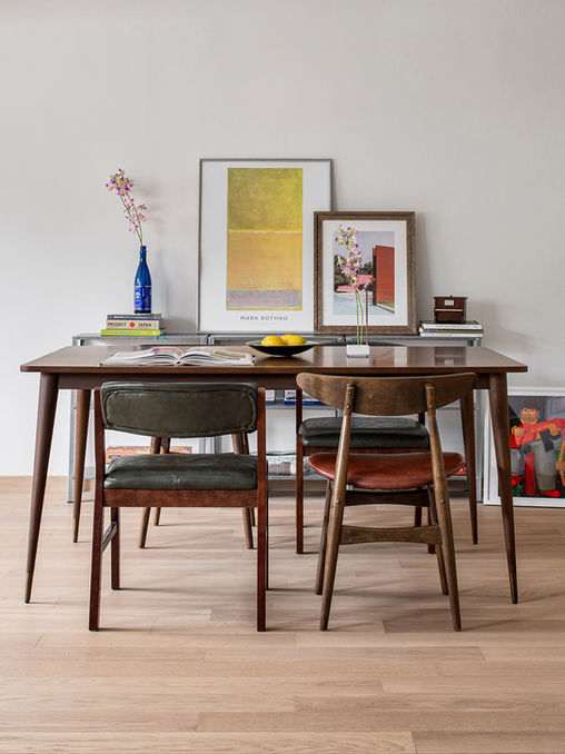Modern dining area with light-toned wood flooring and mid-century furniture accents