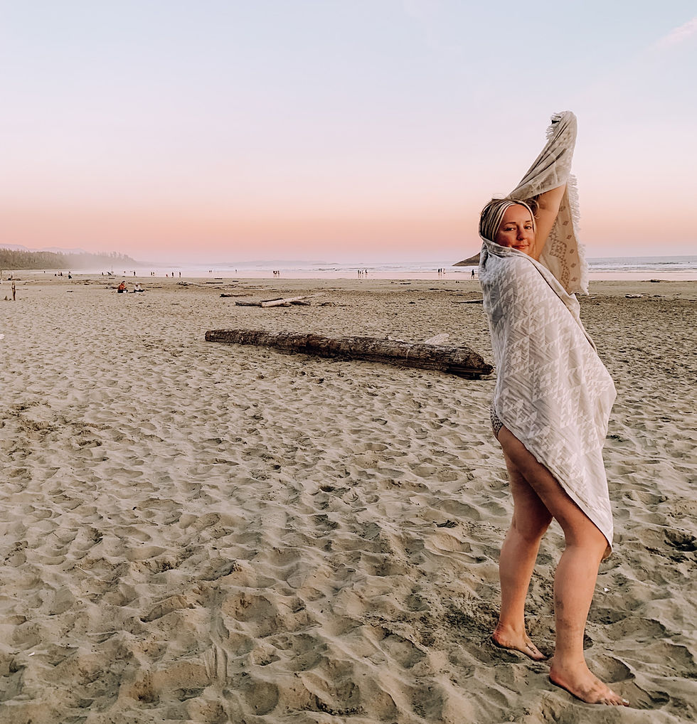 Vancouver Blogger, Taylor White, on Long Beach in Tofino, BC, during sunset. Wrapped in a Tofino Towel Co Beach Towel.