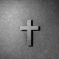 Paper cut cross laying on a paper backgr