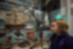 A small child looks at a wooden ship in a display case in Nanton, Alberta SouthWest.