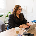 Young woman working on laptop from a home office