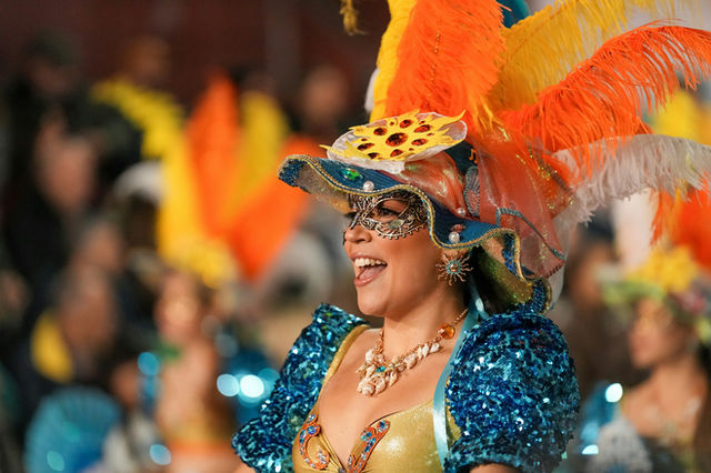 Masked and smiling in the procession — the Madeira carnival