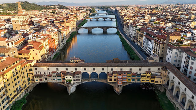 A breathtaking aerial view of Ponte Vecchio and the Arno River in Florence, Italy.