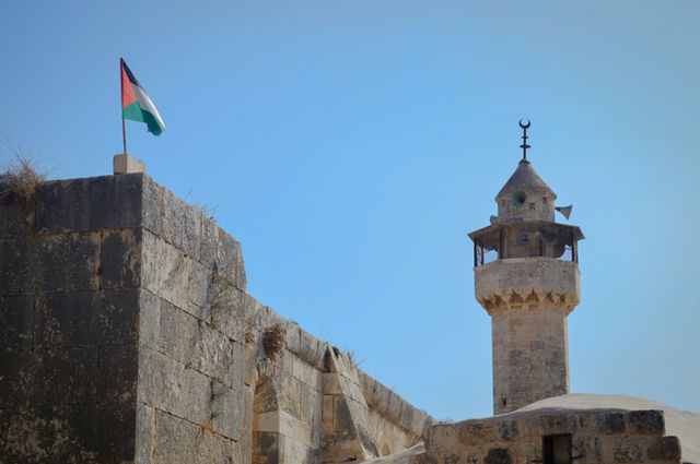 Palestinian flag and a mosque minaret