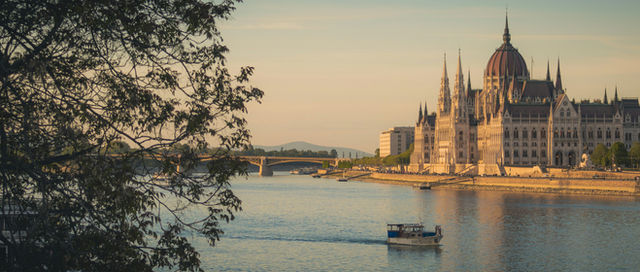 A boat cruising down the Danube river past the Hungarian Parliament