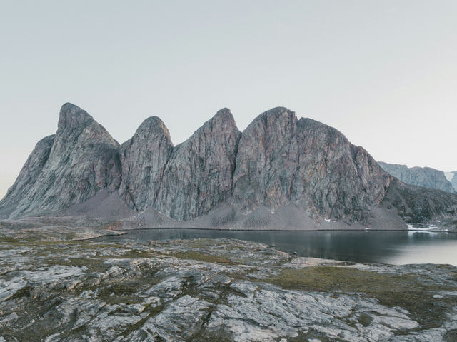 a mountain range with a body of water in the foreground