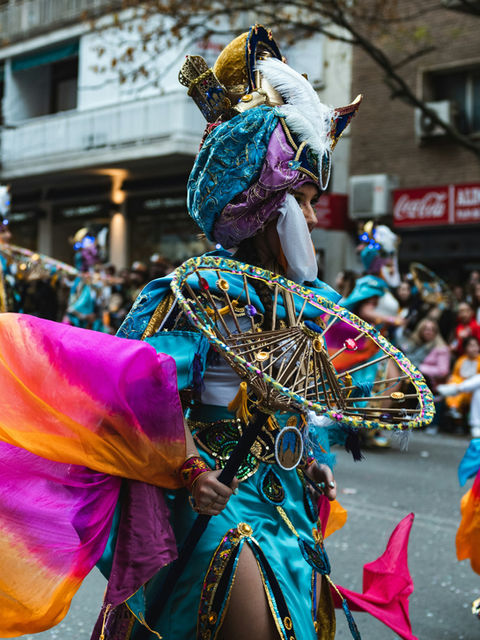 A gilded sunburst carried through the street, robes flaring