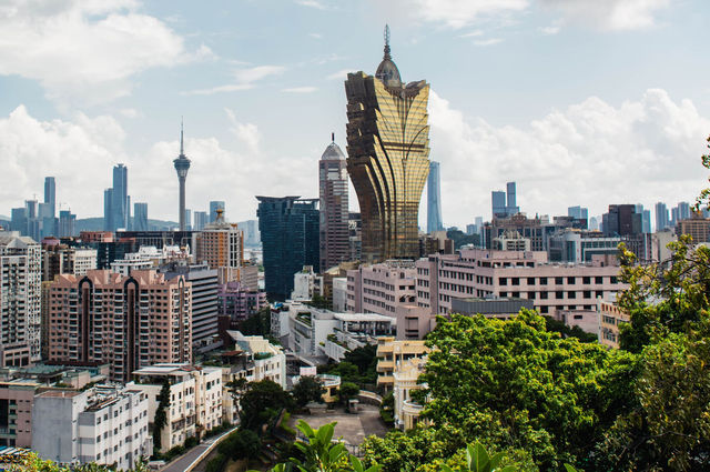 A stunning view of Macao's skyline featuring the Grand Lisboa hotel and casino.