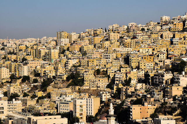 Densely packed urban buildings in Amman, Jordan captured from above, showcasing cityscape.