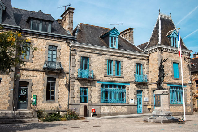 Charming historic architecture with statue in Dol-de-Bretagne, Brittany, France on a sunny day.