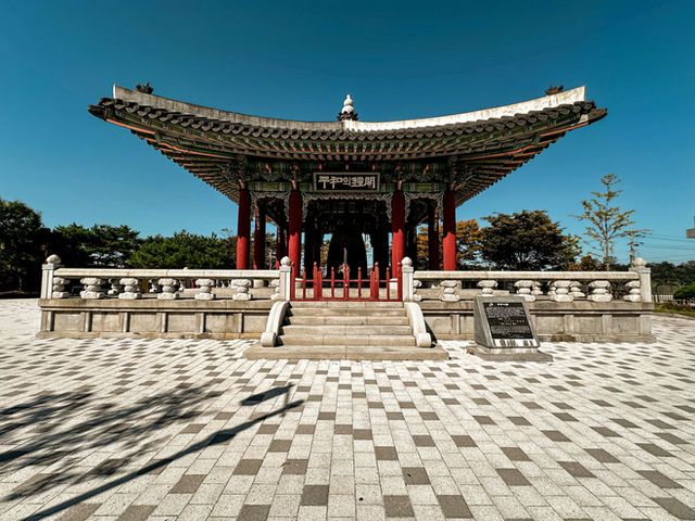 a building with a checkered floor and a tower in the background