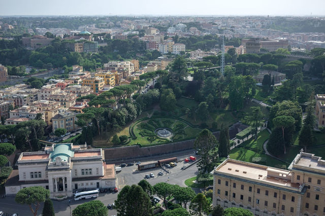 A stunning aerial view showcasing Vatican City's lush gardens and urban layout.