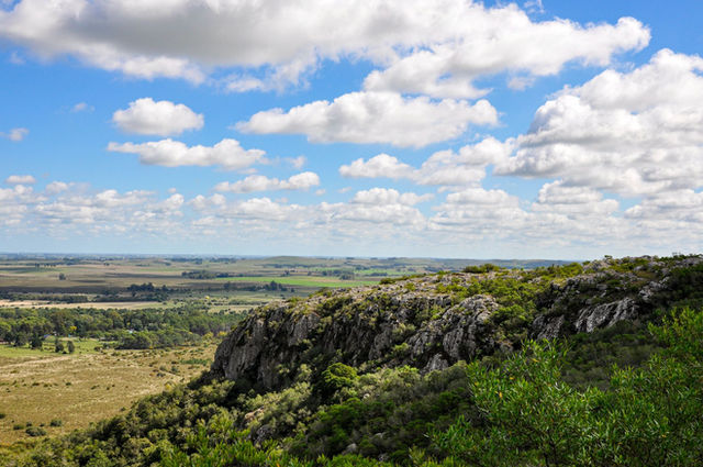 Beautiful rocky landscape with lush greenery under a bright blue sky in Lavalleja, Uruguay.