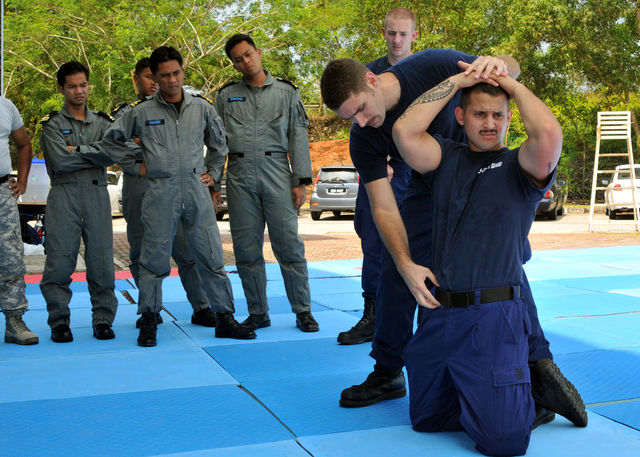 KUANTAN, Malaysia (June 8, 2011) - Malaysian Coast Guardsmen watch as U.S. Coast Guard Maritime Safety and Security Team trainers demonstrate search and detain operations during Co