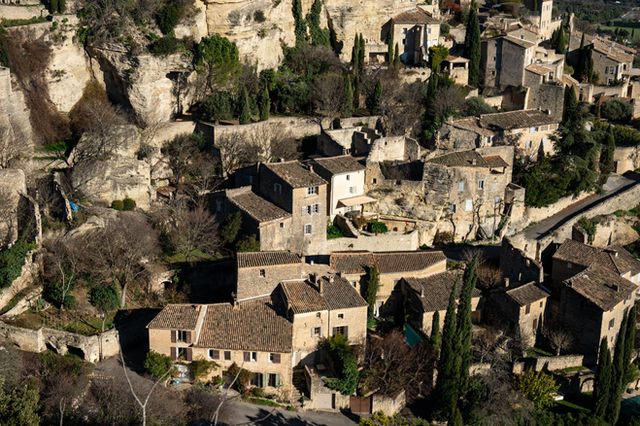 Aerial shot of Gordes, a stunning medieval village in Provence, showcasing rustic stone buildings.