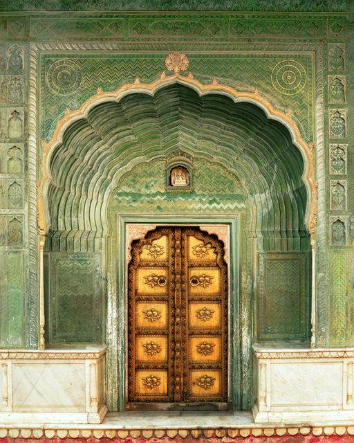 The green gate at Patrika, brass-studded