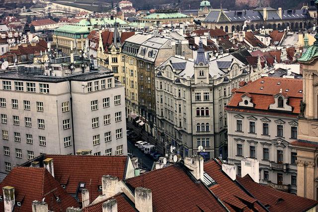 Explore Prague's charming historic architecture with red rooftops and intricate details from above.